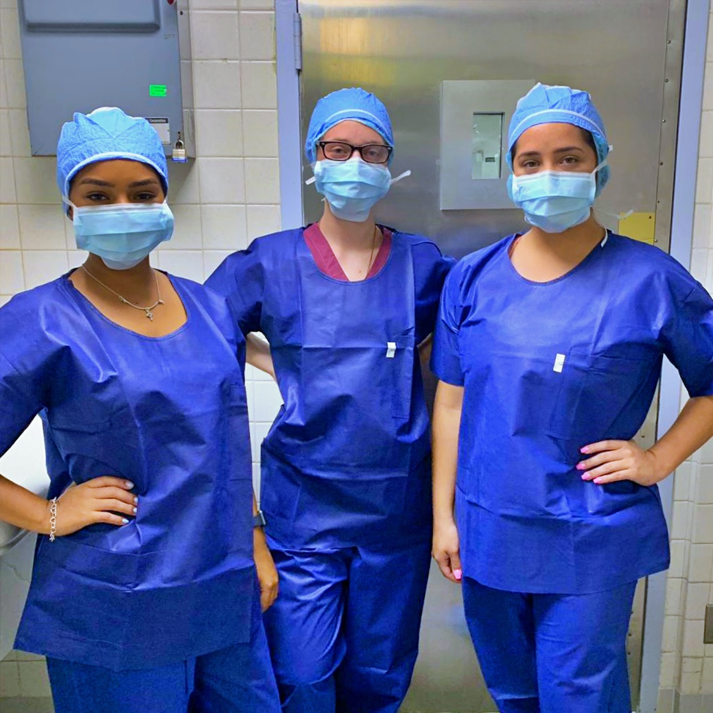 3 nurses in scrubs and wearing face masks
