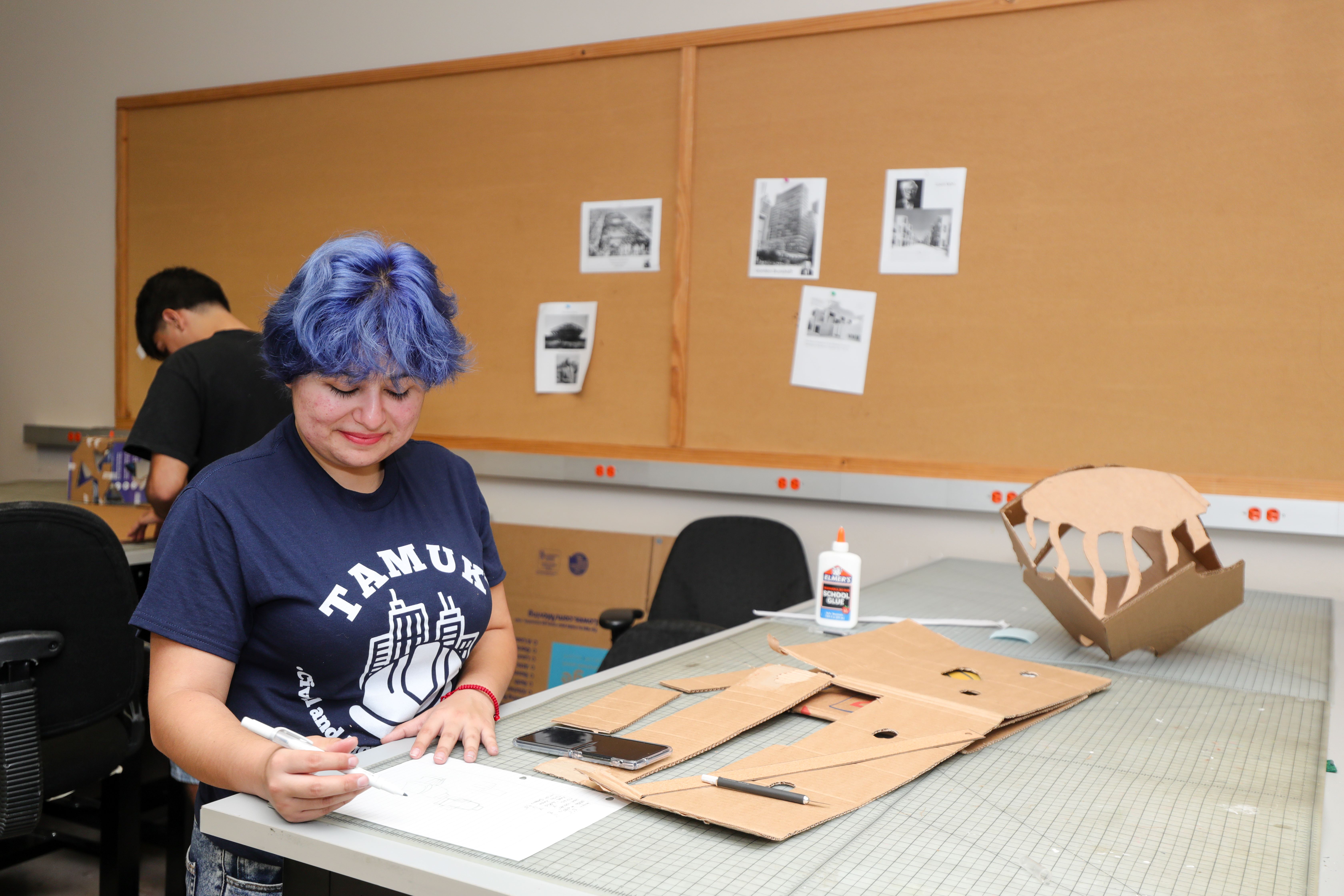 Student working in architectural design studio. 