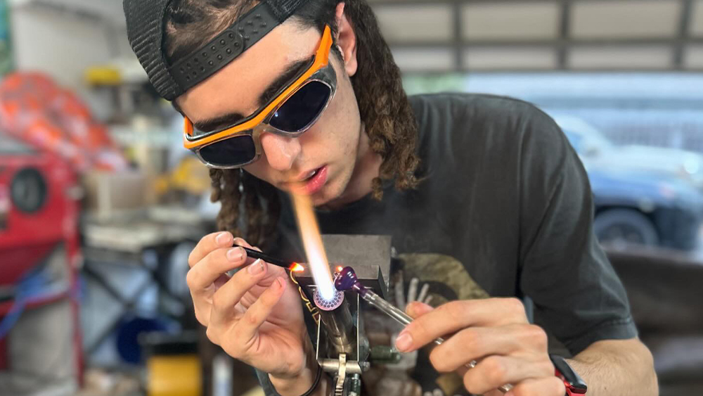 Anthony Zane Anderson focuses on the fine details of glassblowing, combining engineering precision with creative expression in Anthony Zane Anderson’s personal home lab.