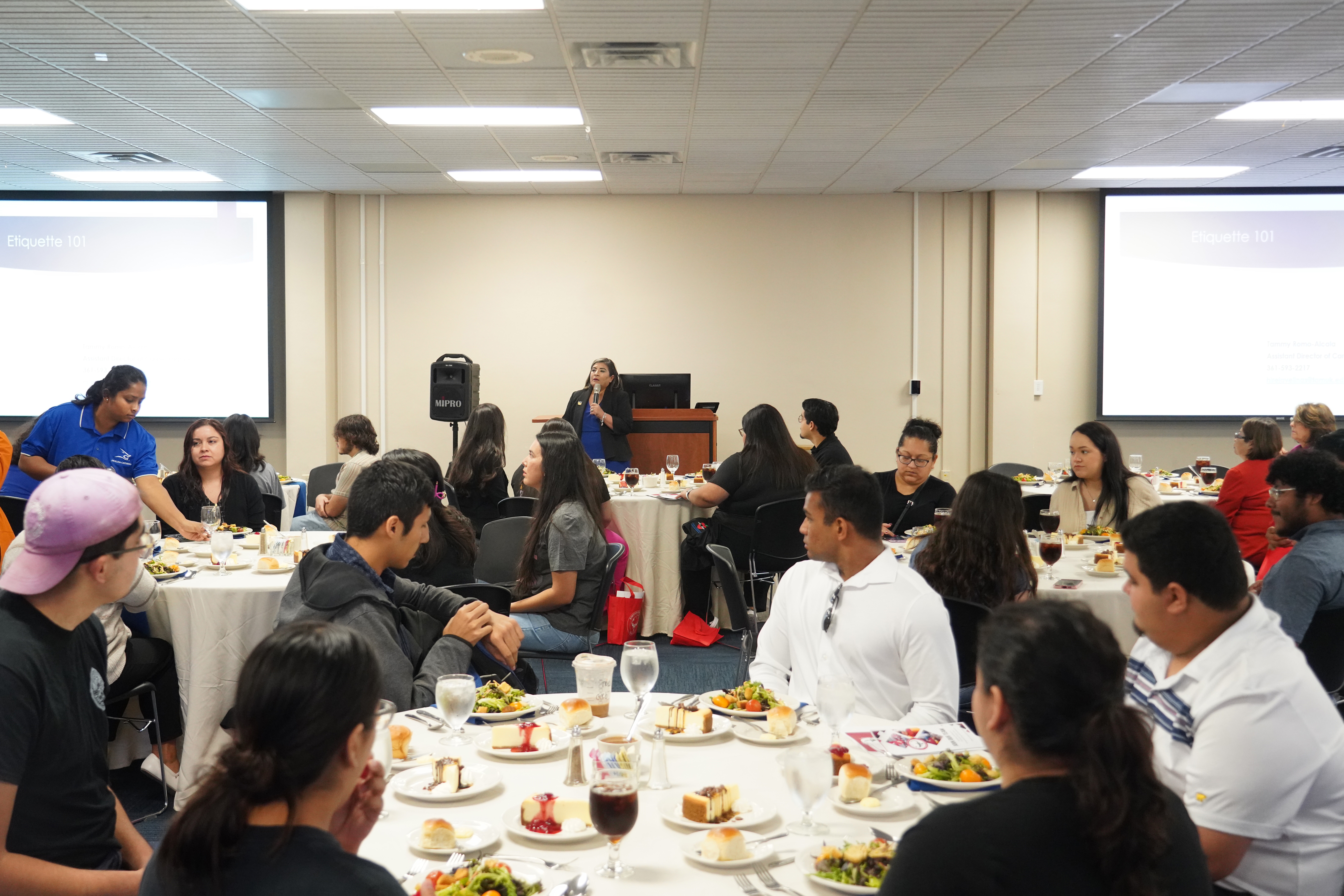 Students learn at an etiquette dinner in Room 219.
