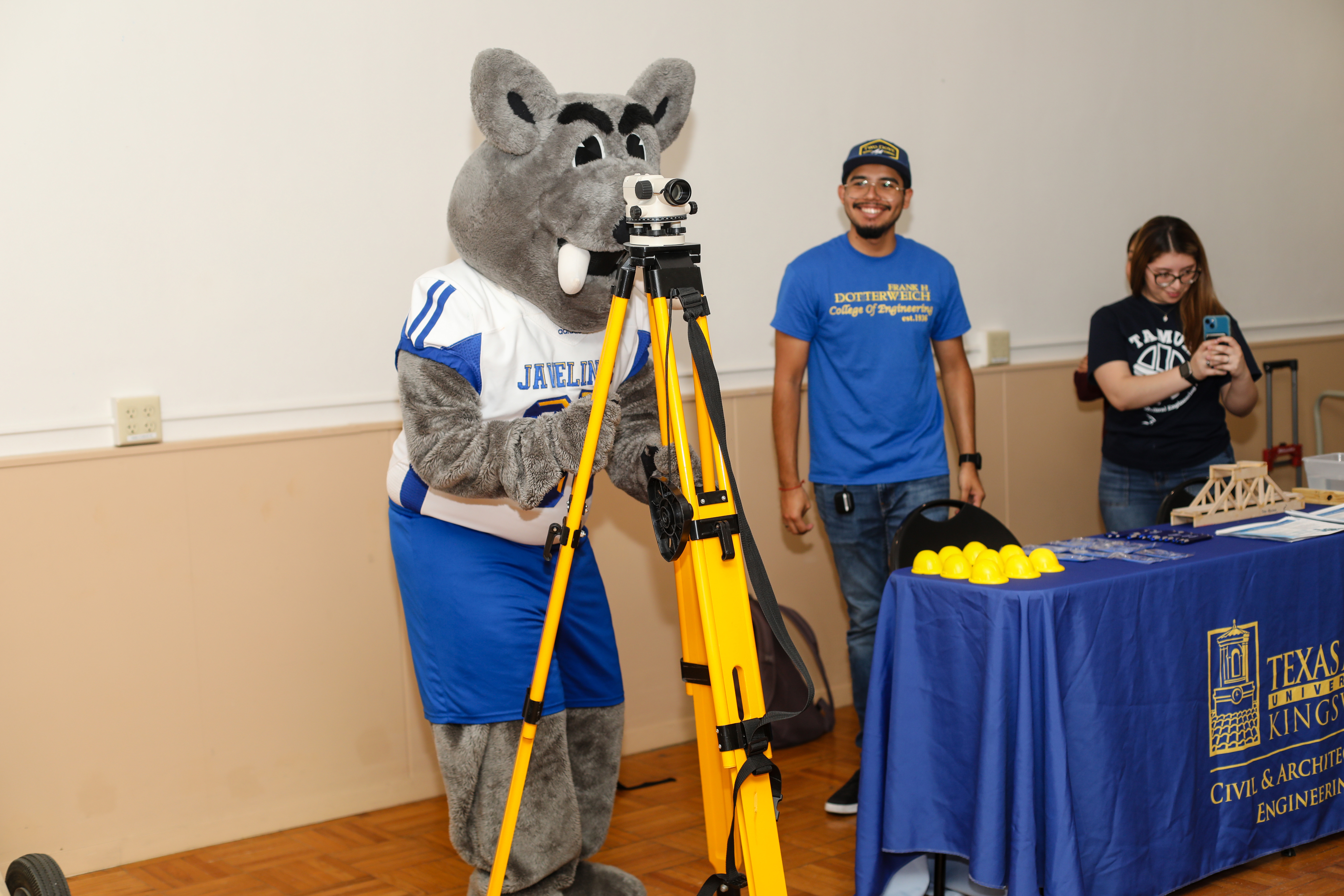 Porky, TAMUK's mascot, is using a piece of engineering equipment in Ballroom B.