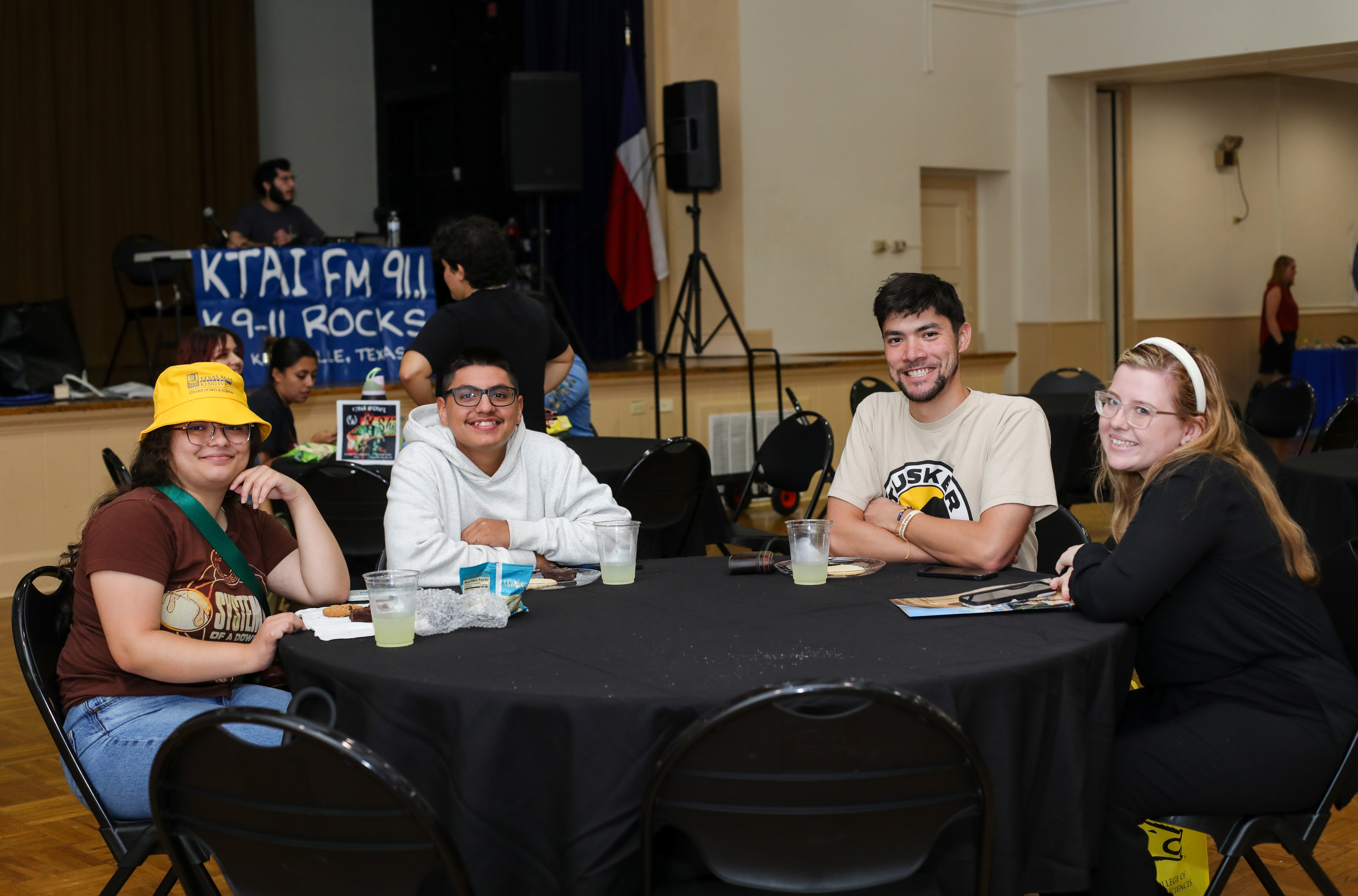 Students smiling for a photo at a Welcome Bash in Ballroom A.