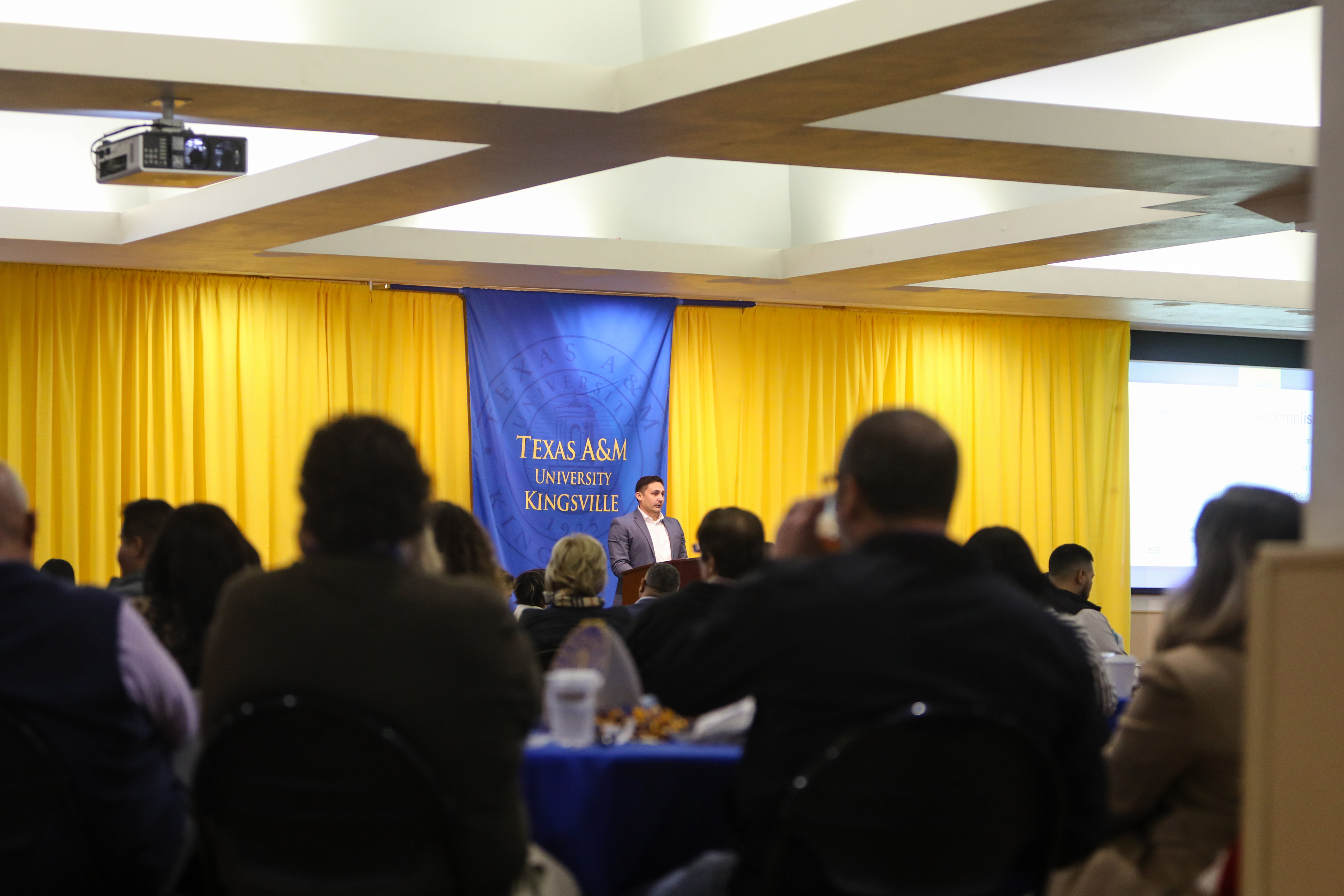 The audience watches the podium speaker present at the Faculty and Staff General Meeting in the MSUB Ballrooms.