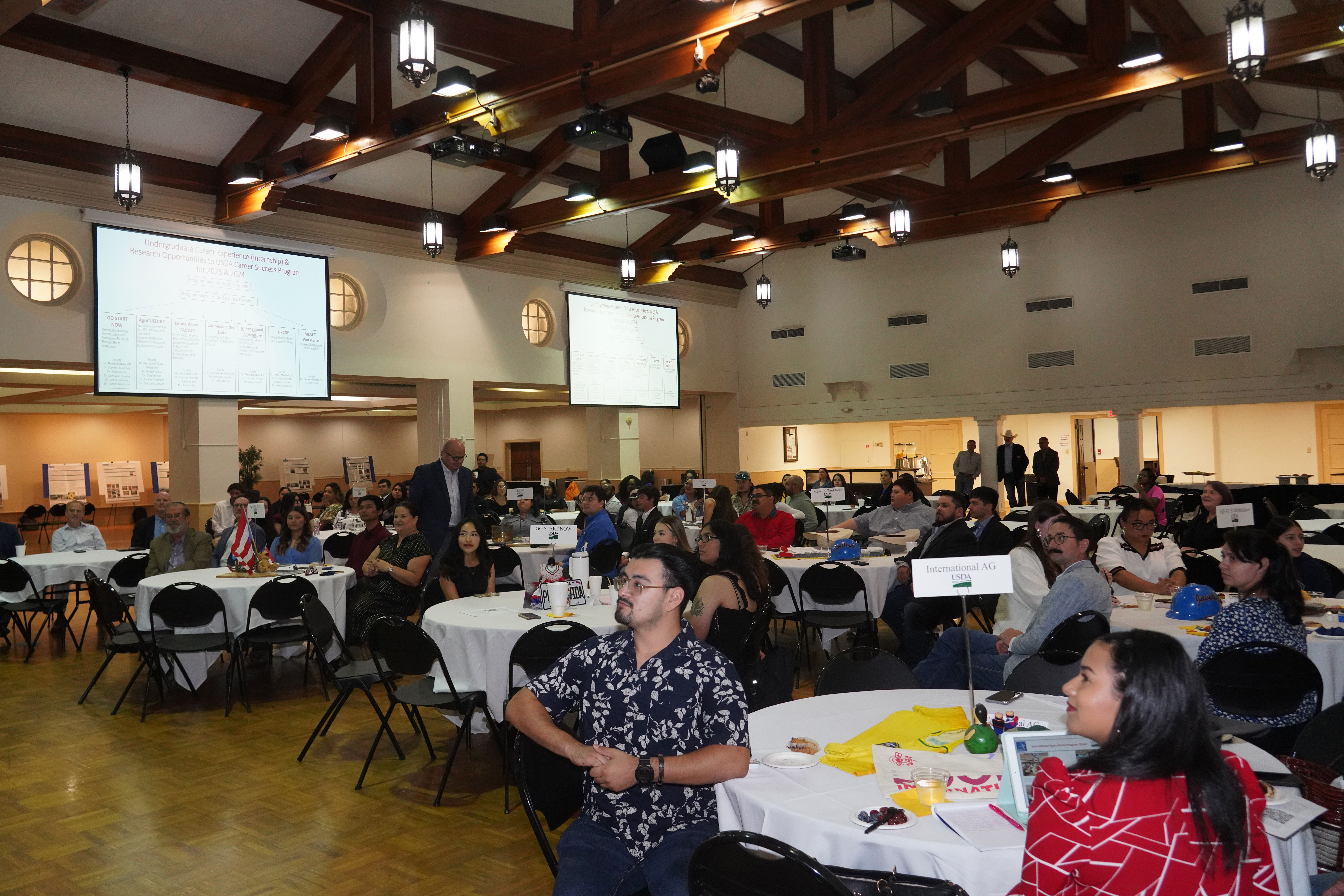 An audience watches the presenter at the Undergraduate Research Showcase in Ballroom A&B.