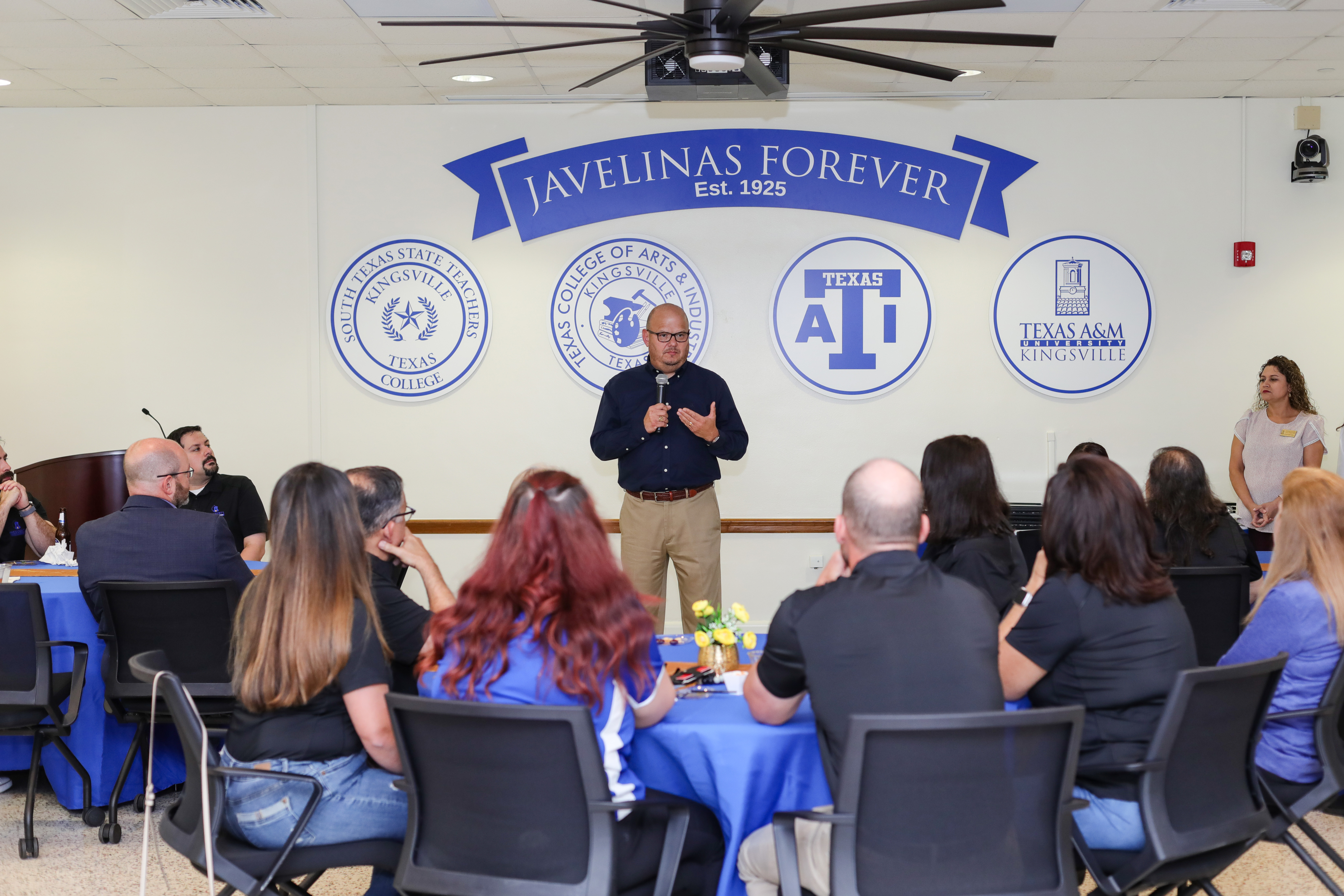 President Vela speaks to candidates of the President's Leadership Academy in the interior space of the Founders Room.