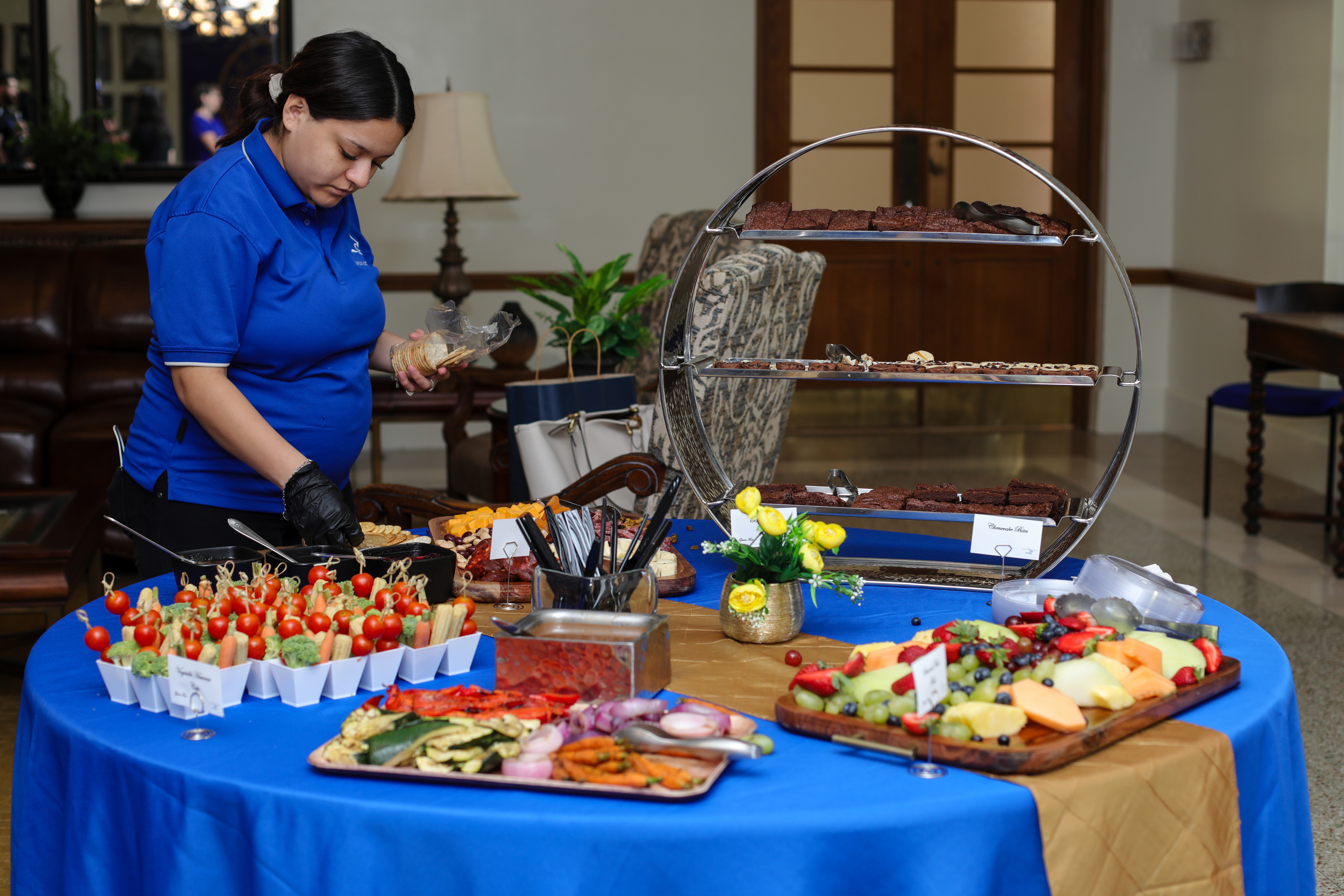 An Aramark employee tends to a spread of food in the Founders Room.